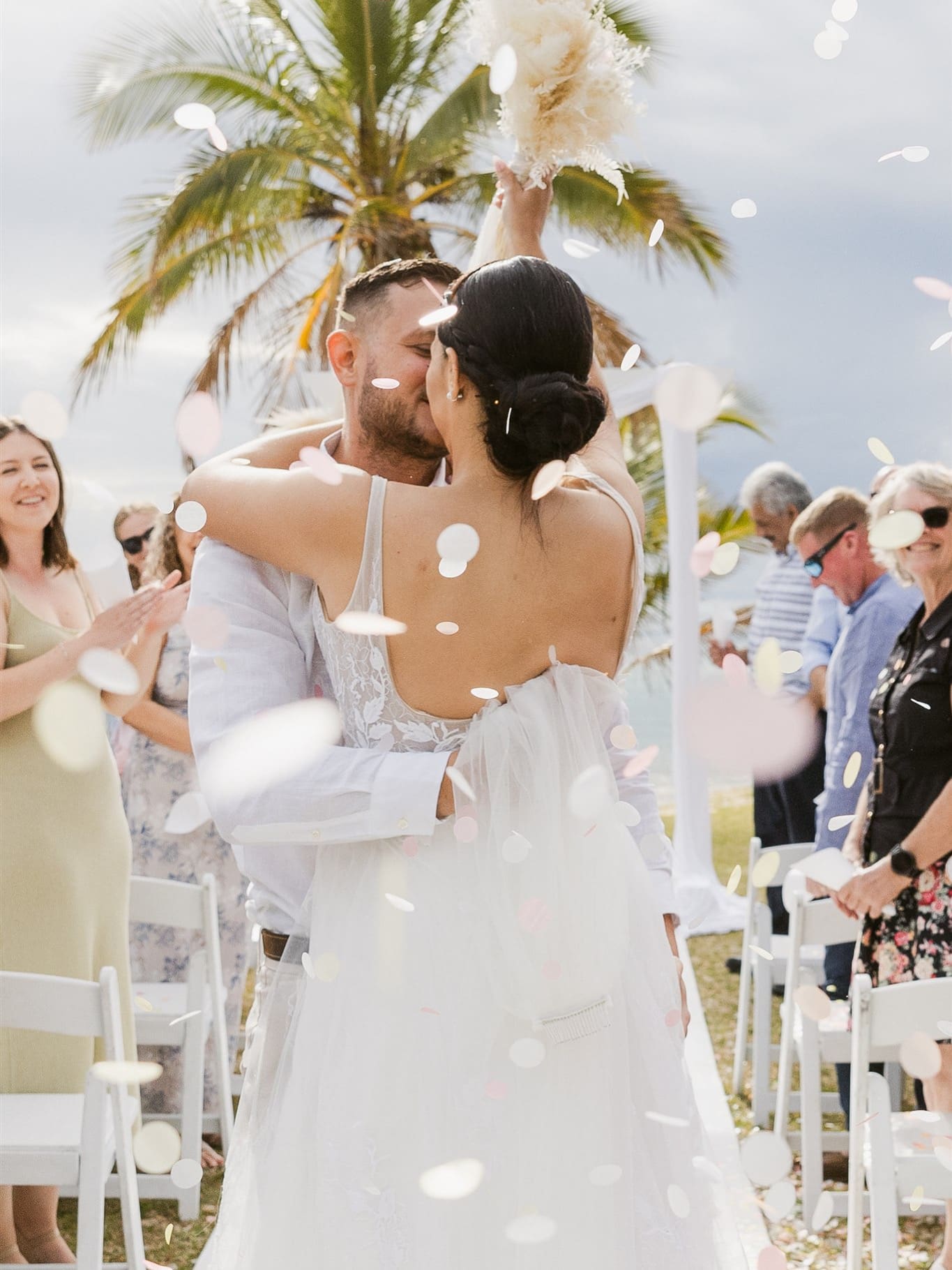 Wedding aisle photo with confetti at tangalooma island photographed by One Avenue Photography