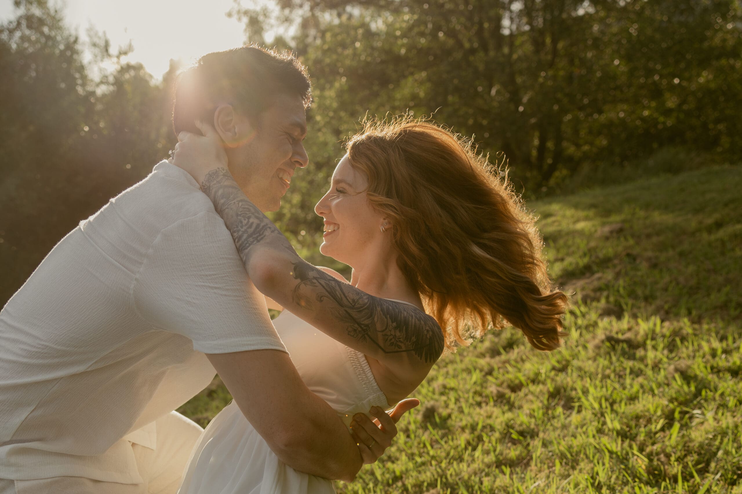 Romantic engagement photo of a man dipping his partner, captured in soft natural light during a Brisbane couples session.